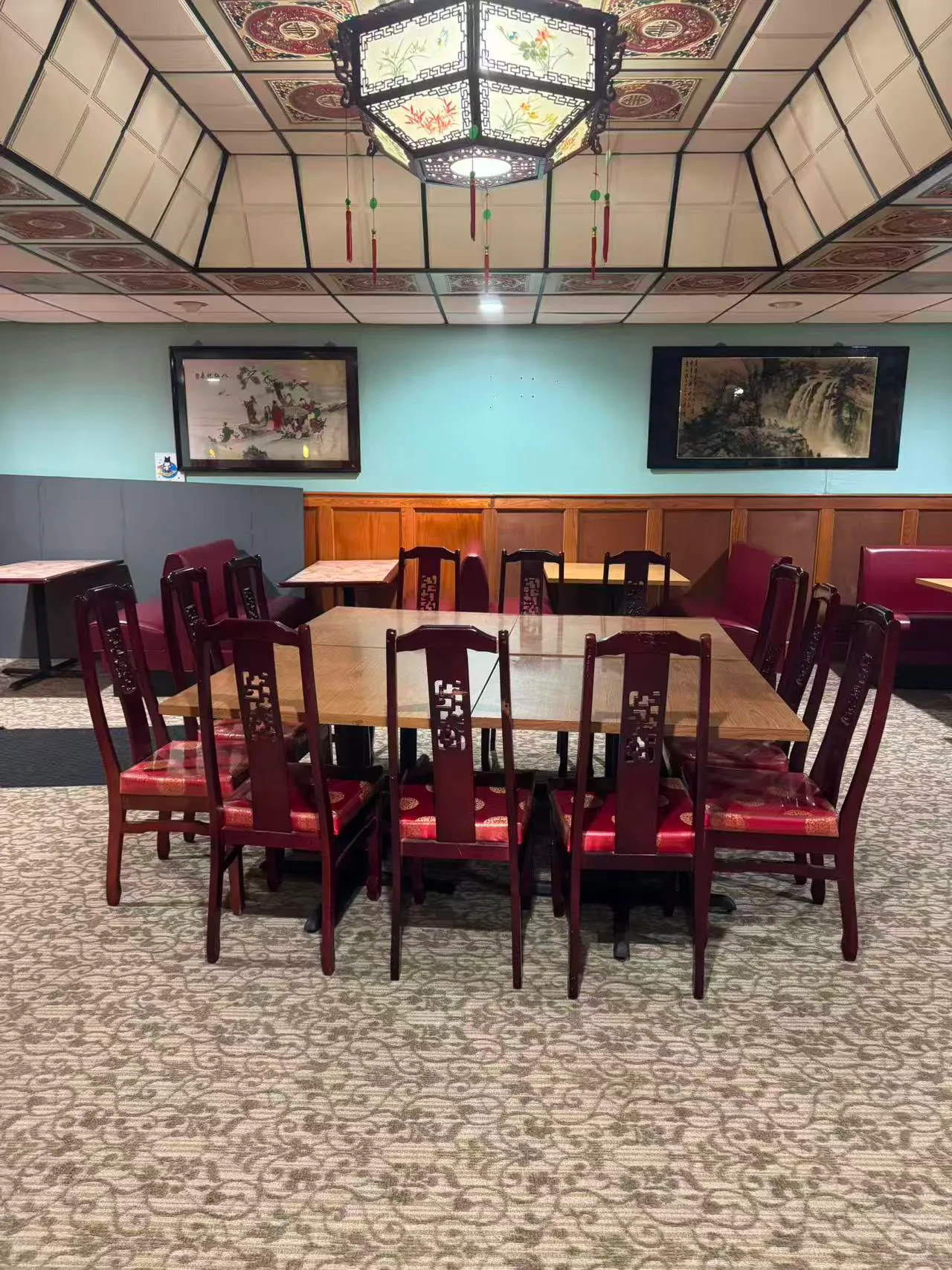 China-King-Chinese-Restaurant-Restaurant-Display-South-Beloit A traditional Chinese restaurant dining room with a large wooden table, red-cushioned chairs, ornate ceiling lanterns, and framed artwork on the walls.